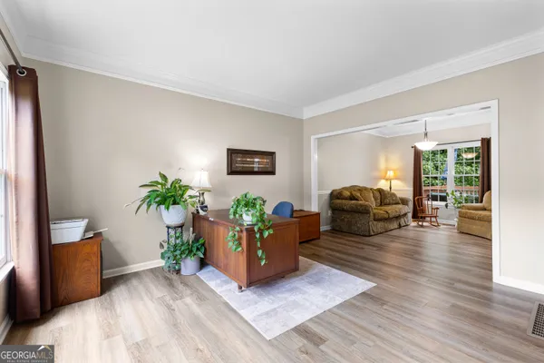 a workspace with furniture window and wooden floor
