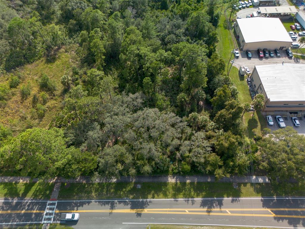 265 Enterprise Road Deltona, FL 32725 - Photo 21 of 24 an aerial view of a house with a yard and lake view