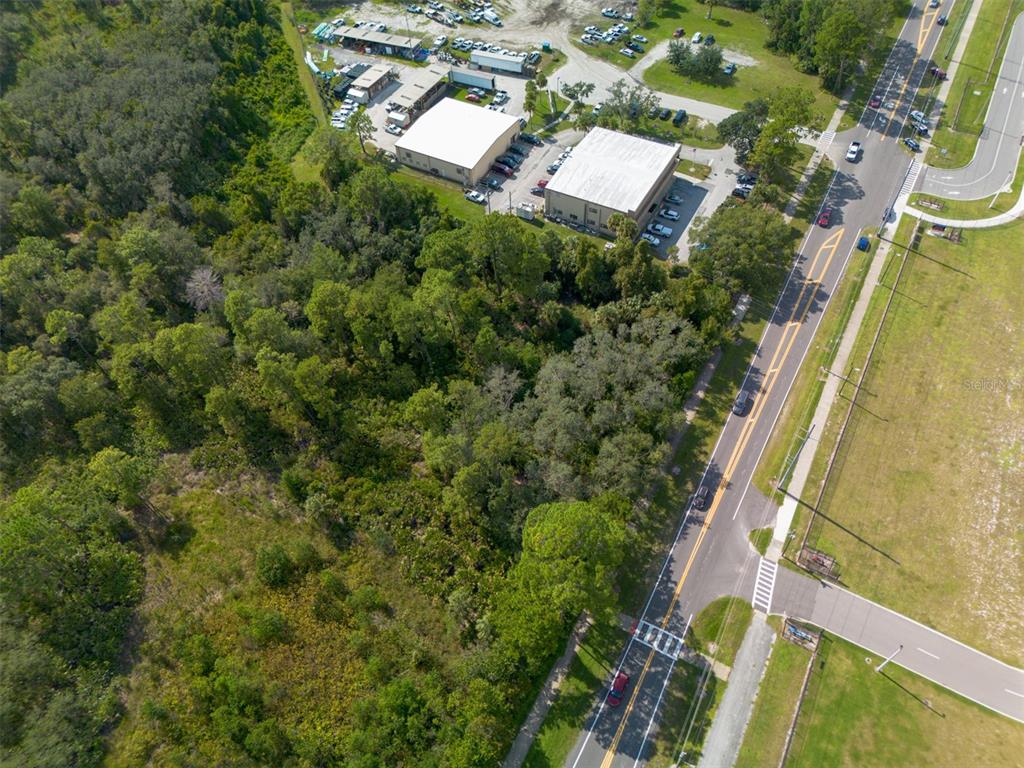 265 Enterprise Road Deltona, FL 32725 - Photo 4 of 24 an aerial view of residential house with outdoor space and trees all around