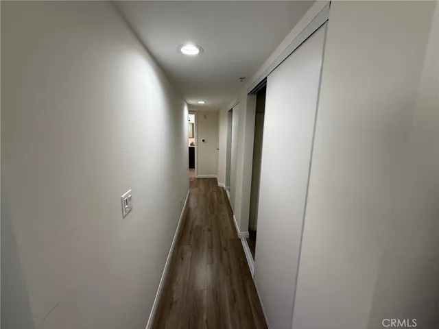 a view of hallway with wooden floor