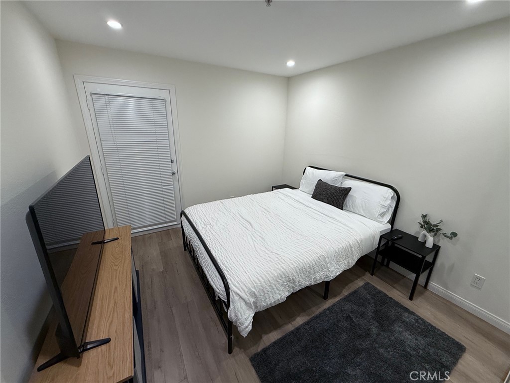 116 West Maple Street, Unit 6 Glendale, CA 91204 - Photo 13 of 19 a bedroom with a bed and a mirror