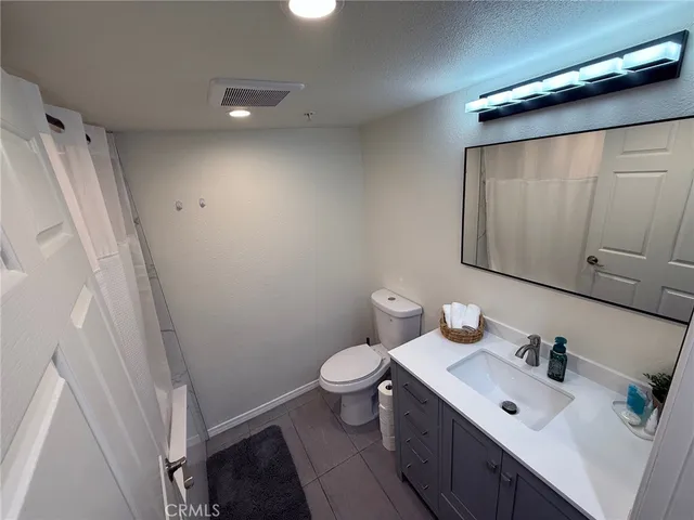 a bedroom with a bed and a mirror