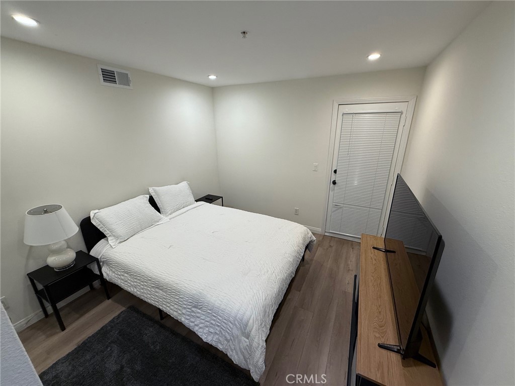 116 West Maple Street, Unit 6 Glendale, CA 91204 - Photo 15 of 19 a bedroom with a bed and a mirror