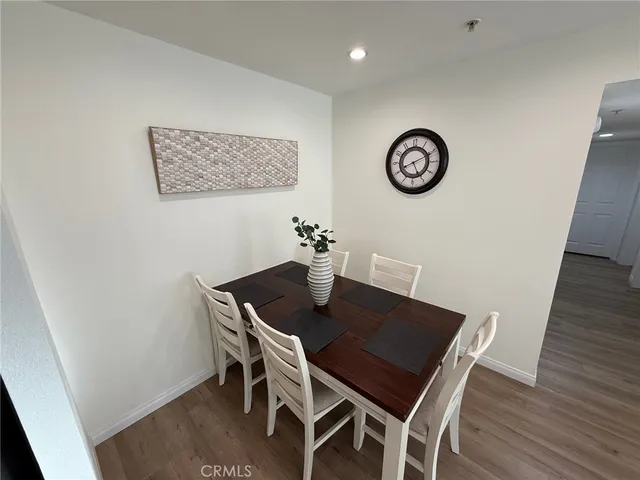 a kitchen with a refrigerator a stove top oven and cabinets