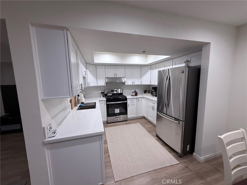 116 West Maple Street, Unit 6 Glendale, CA 91204 - Photo 8 of 19 a kitchen with a refrigerator a stove top oven and cabinets