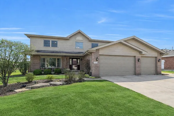 a front view of house with yard and green space