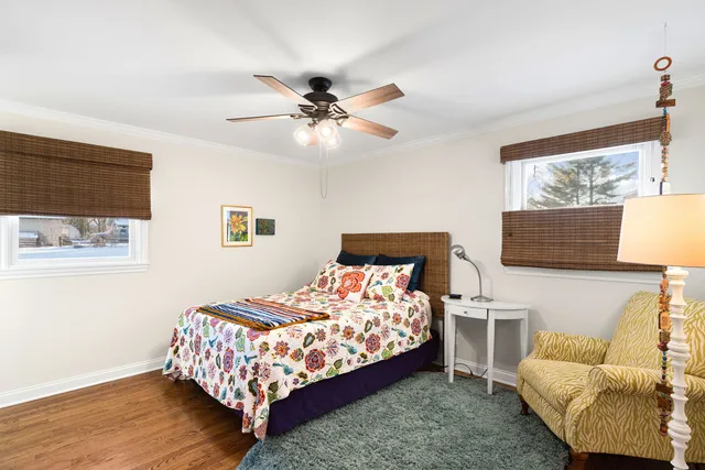 a bedroom with a bed a couch and a dresser