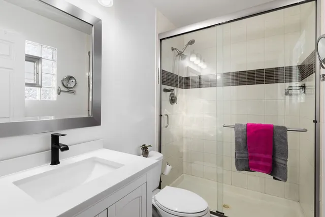 a bathroom with a sink toilet and shower