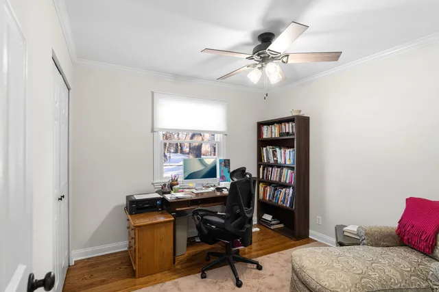 a view of a workspace with furniture and a window