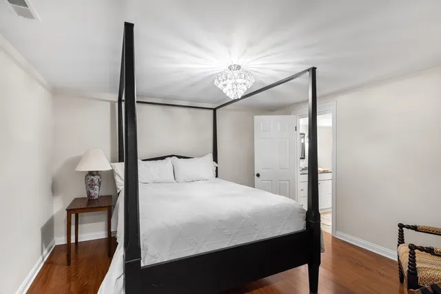 a bedroom with a bed and a chandelier