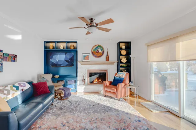 a living room with furniture a clock and a fireplace