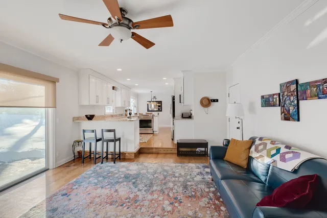 a living room with furniture and kitchen view