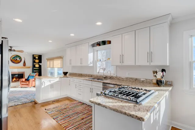 a kitchen with a stove and white cabinets