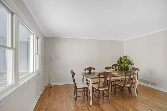a view of a dining room with furniture and wooden floor