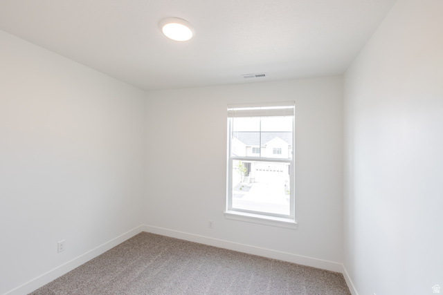 675 West 4500th South, Unit P201 Mapleton, UT 84664 - Photo 5 of 16 Neutral tone wall finishes with a window featuring horizontal blinds, recessed ceiling lighting, and gray carpet flooring