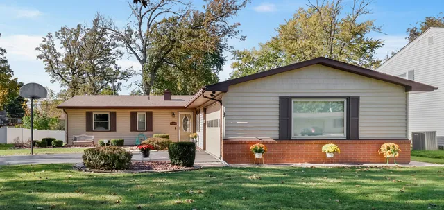 a front view of house with yard and outdoor seating