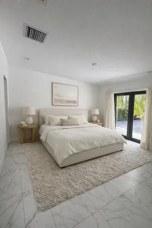 a bedroom with a large bed and a couch