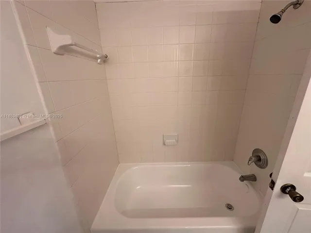 a white bath tub sitting in a bathroom