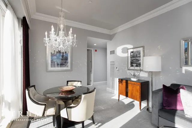 a view of a dining room with furniture and chandelier