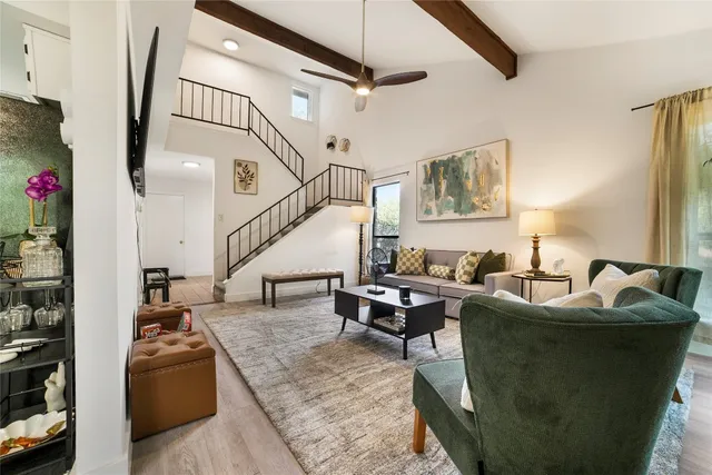 a living room with furniture and a potted plant