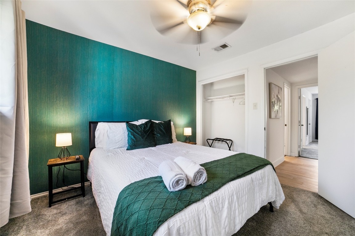 2009 Kenneth Avenue, Unit A Austin, TX 78741 - Photo 12 of 17 a bedroom with a bed and a chandelier