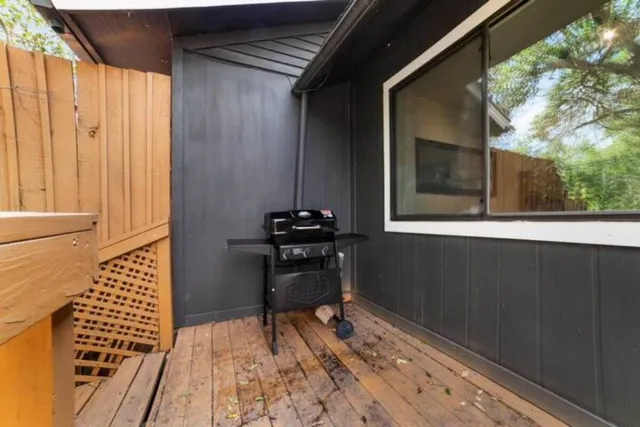 a view of a balcony and chairs and wooden floor