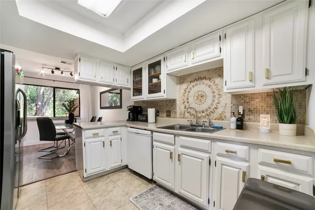 a kitchen with cabinets appliances and a counter top space