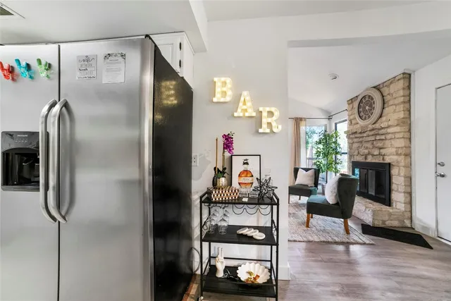 a kitchen with furniture and a refrigerator