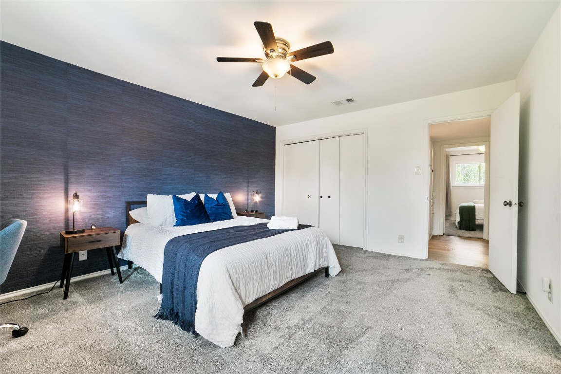 2009 Kenneth Avenue, Unit A Austin, TX 78741 - Photo 8 of 17 a spacious bedroom with a bed and a chandelier