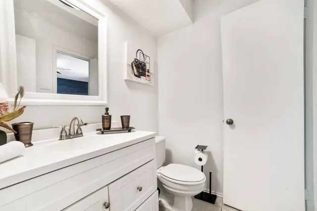 a bathroom with a toilet sink and mirror