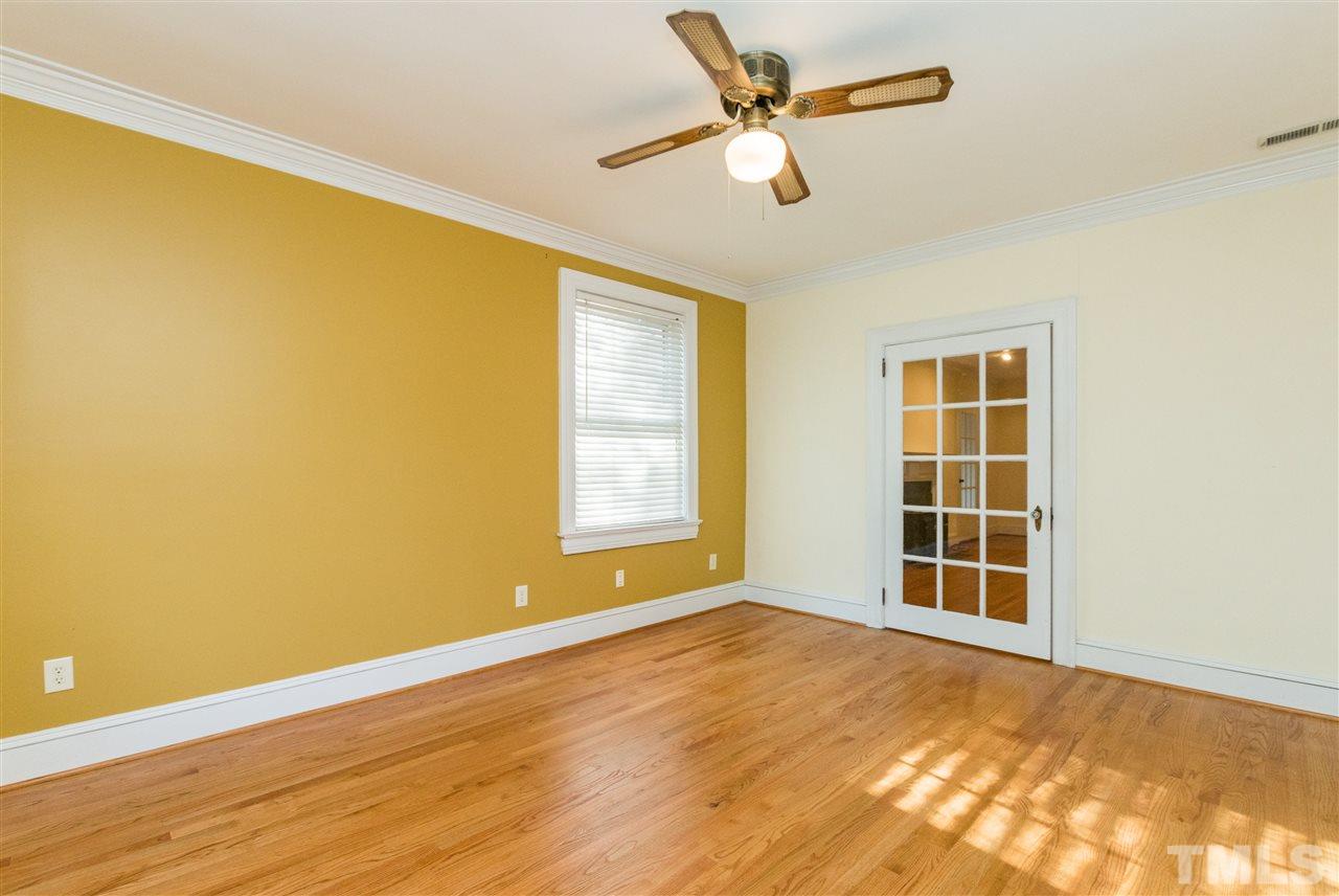 509 Burton Street Raleigh, NC 27608 - Photo 12 of 25 a view of an empty room with wooden floor and a window