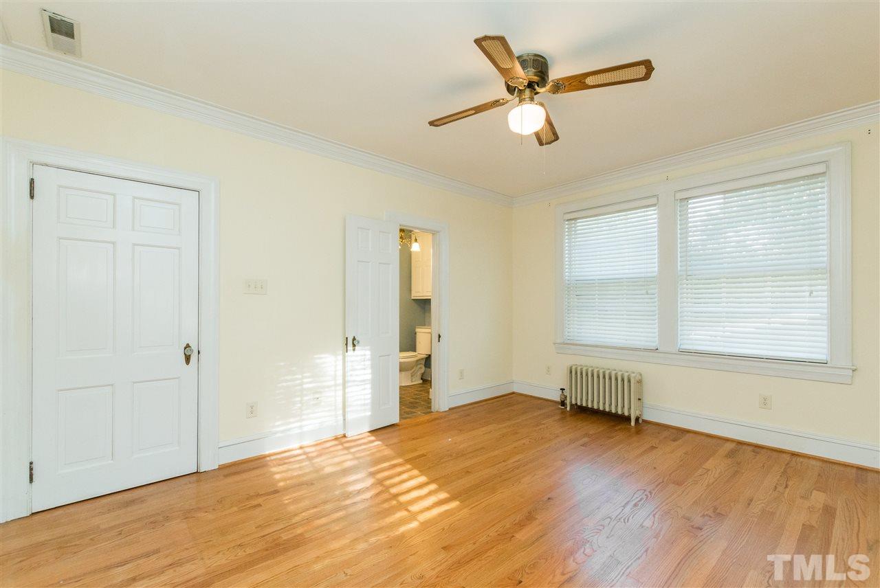 509 Burton Street Raleigh, NC 27608 - Photo 13 of 25 a view of empty room with wooden floor and fan