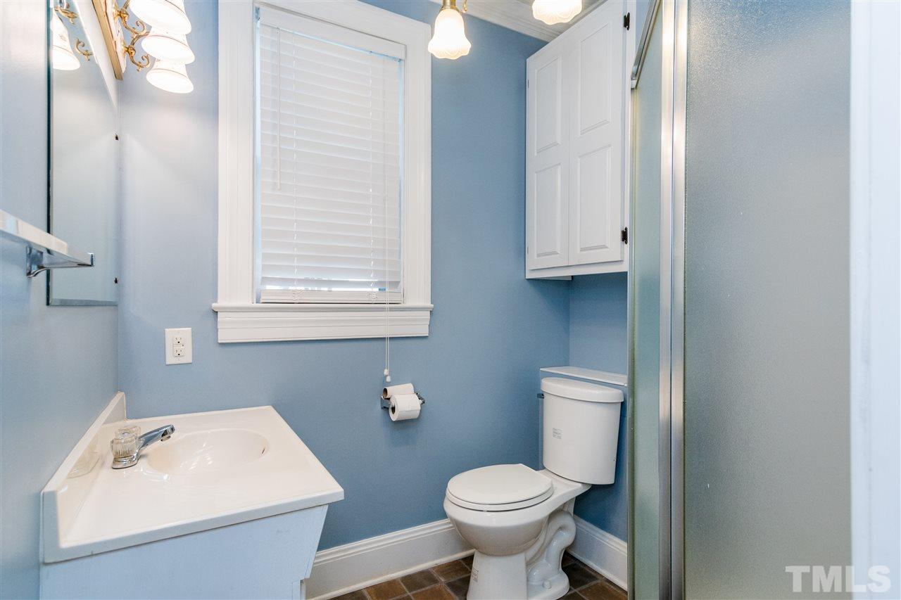 509 Burton Street Raleigh, NC 27608 - Photo 14 of 25 a bathroom with a sink a toilet and a mirror