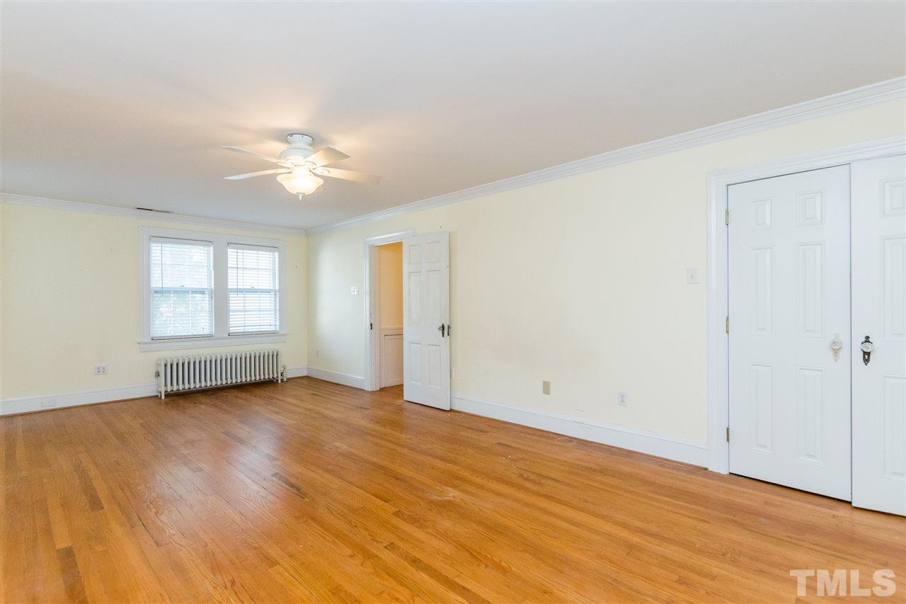 509 Burton Street Raleigh, NC 27608 - Photo 15 of 25 an empty room with wooden floor and window