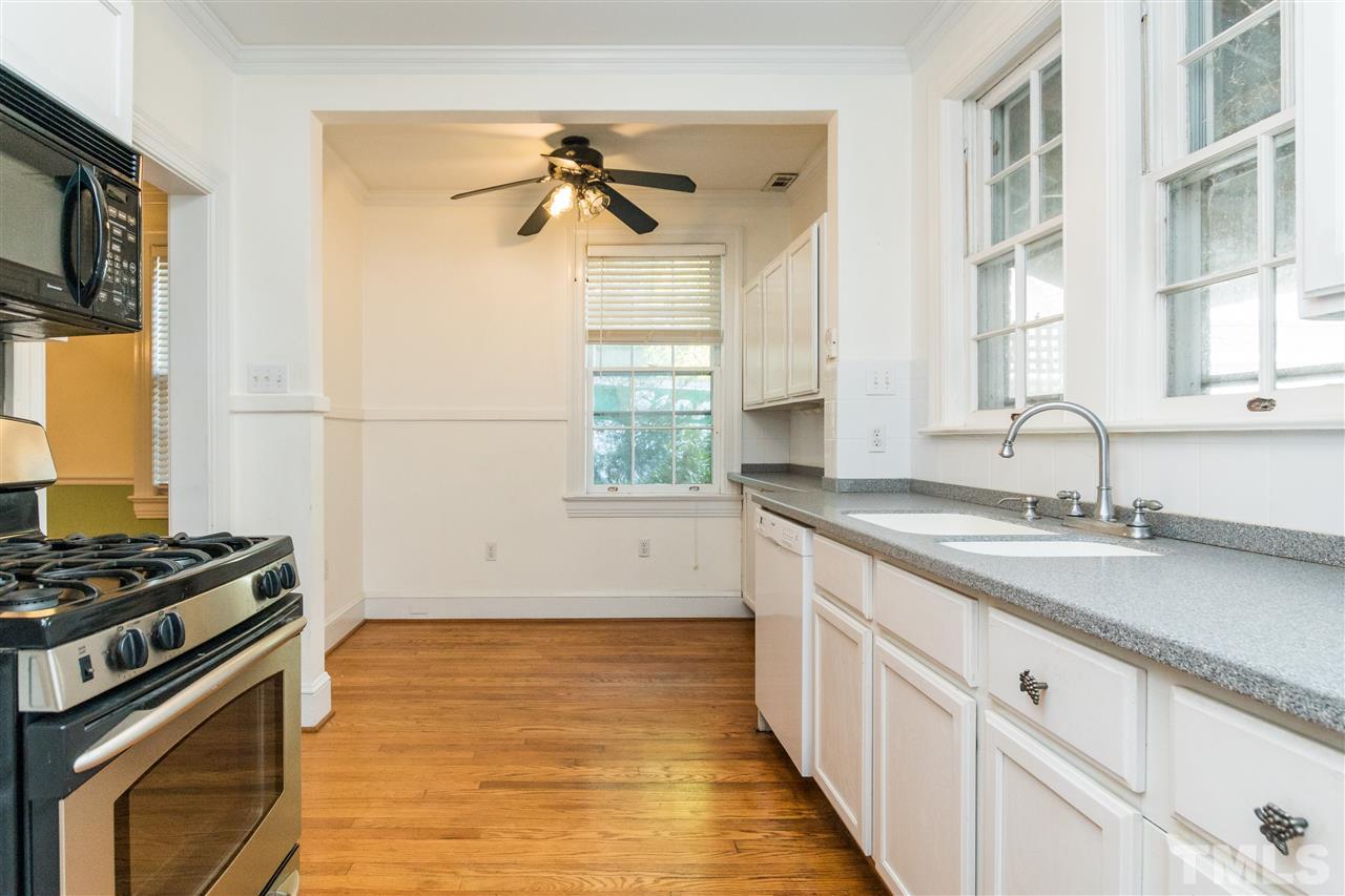 509 Burton Street Raleigh, NC 27608 - Photo 7 of 25 a kitchen with stainless steel appliances a sink stove and cabinets