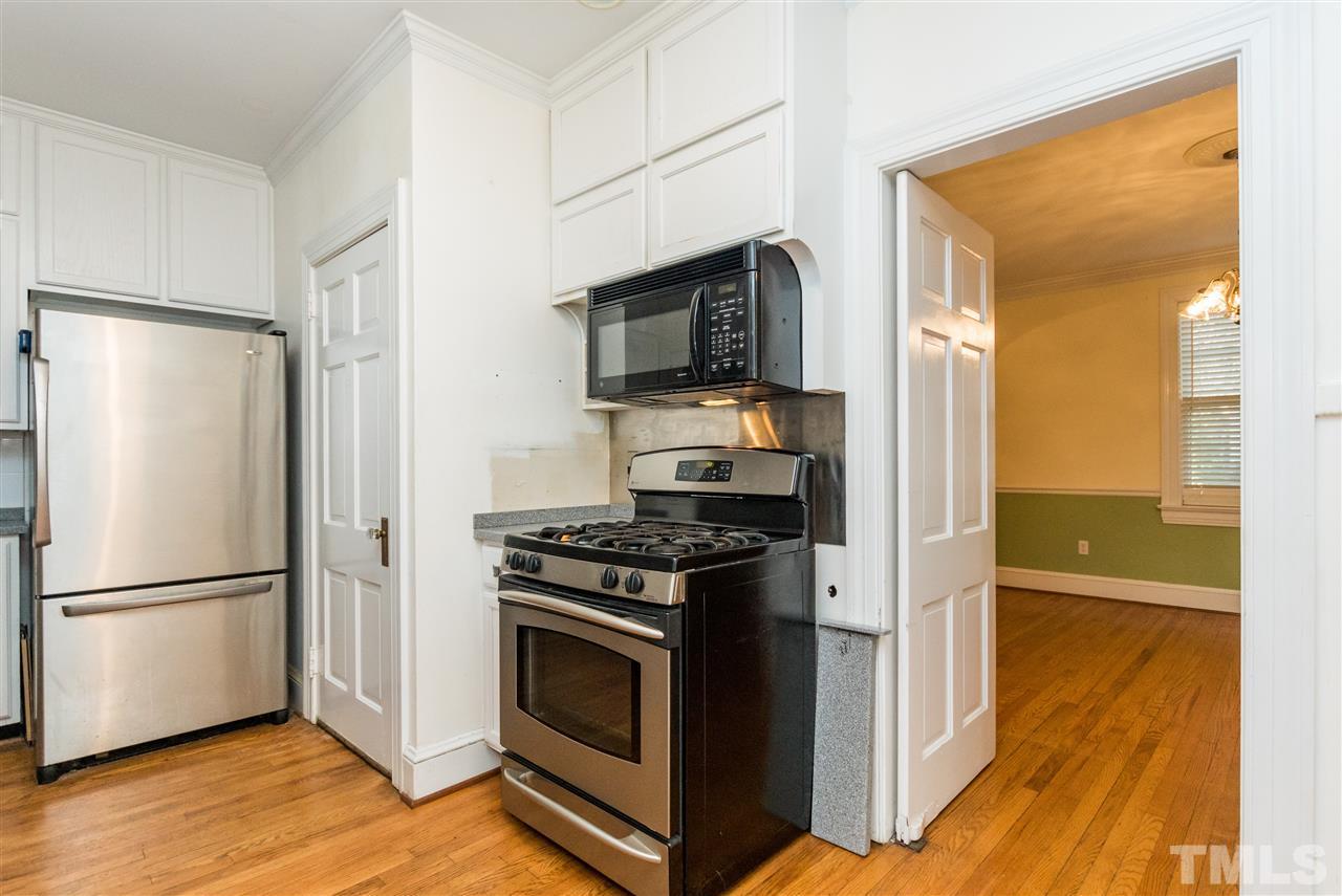 509 Burton Street Raleigh, NC 27608 - Photo 9 of 25 a kitchen with stainless steel appliances granite countertop a refrigerator stove and sink