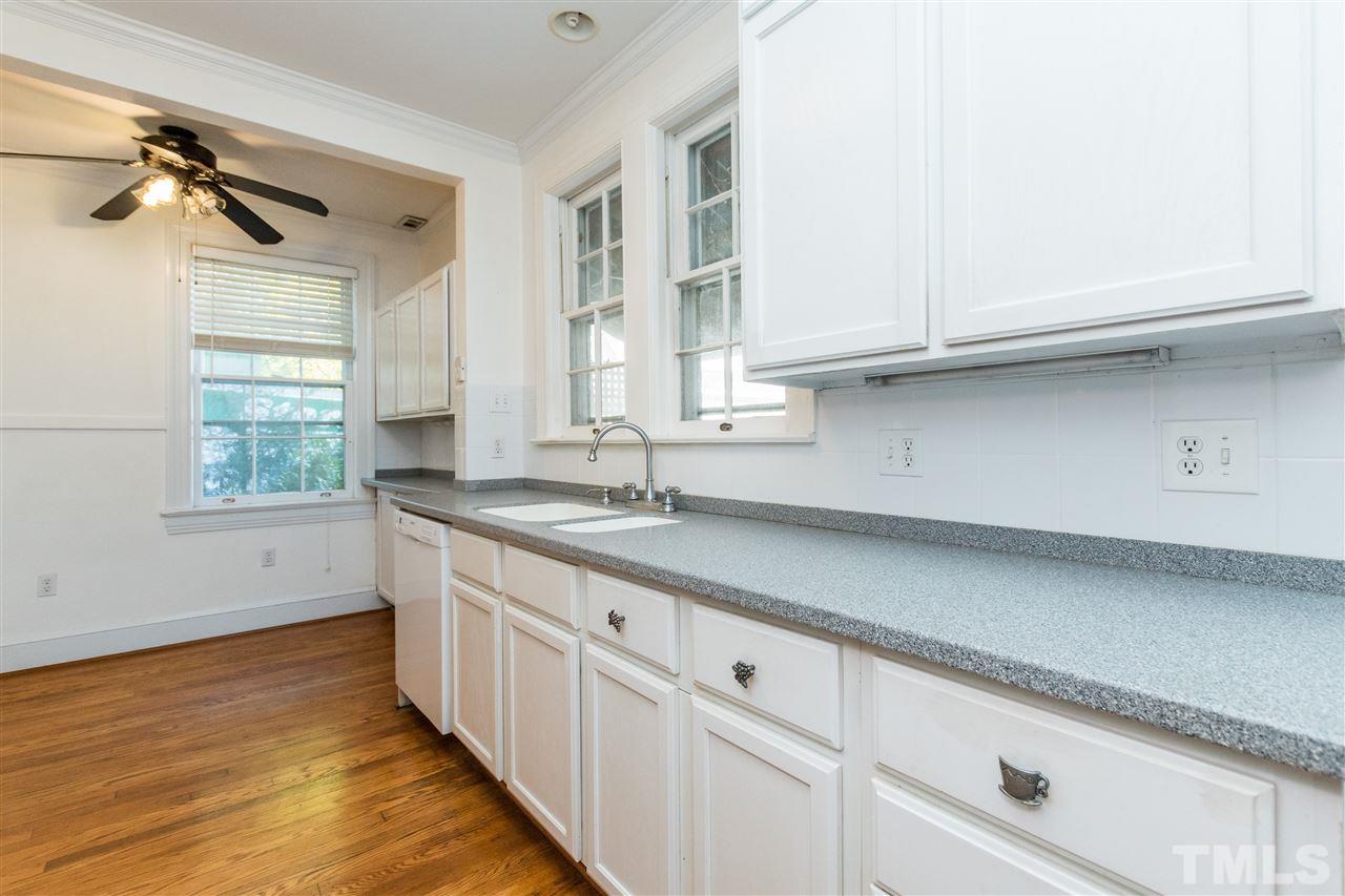 509 Burton Street Raleigh, NC 27608 - Photo 10 of 25 a kitchen with granite countertop white cabinets and a sink