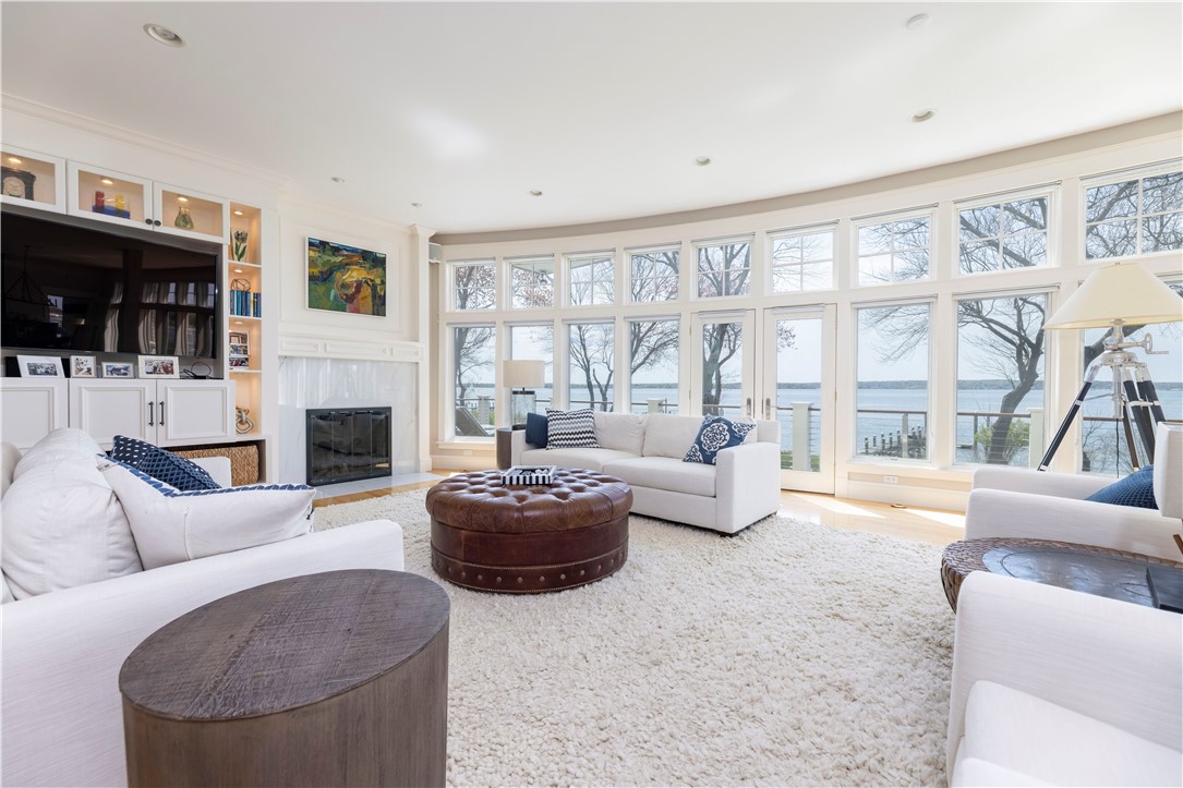 196 Channel View Warwick, RI 02889 - Photo 10 of 50 Gorgeous living room with a wall of windows. The transom window motif is carried throughout.