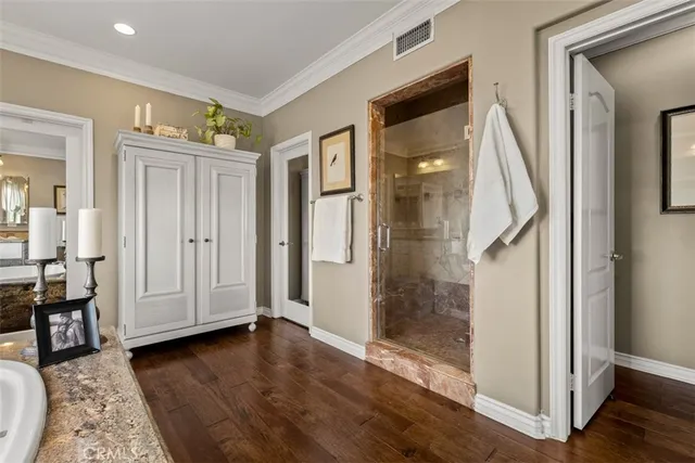 a en suite bathroom with a granite countertop sink and a mirror