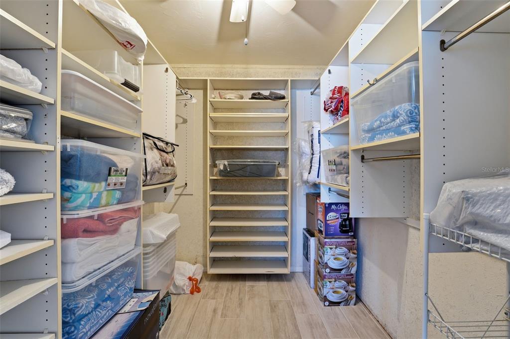 4440 Exeter Drive, Unit 106 Longboat Key, FL 34228 - Photo 11 of 26 a view of walk in closet with clothes and shoes