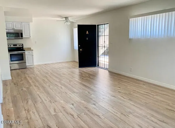 a view of a kitchen with an empty space and a window