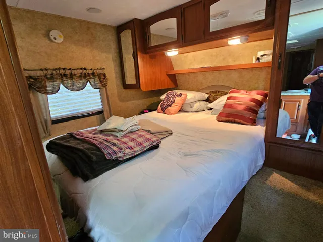 a bedroom with a bed and window