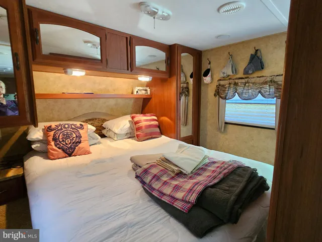 a bedroom with a bed and painting on the wall