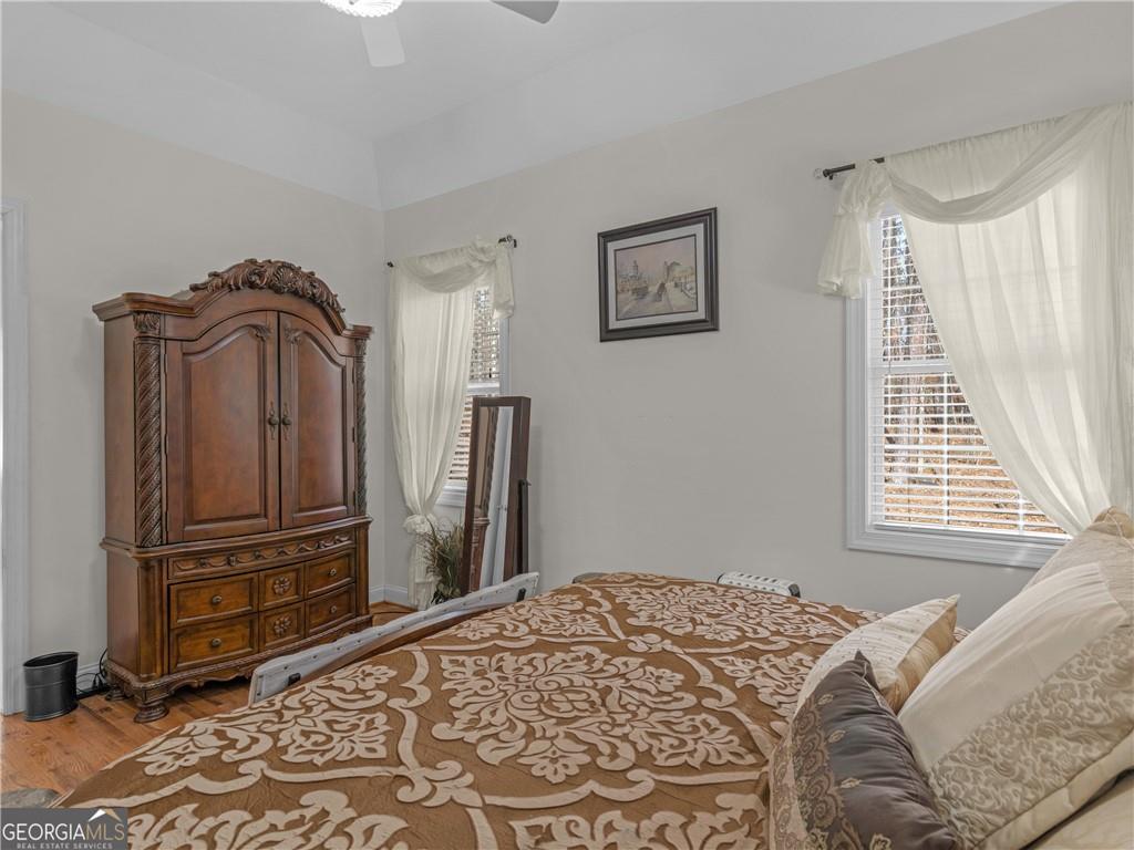 355 Parker Road Covington, GA 30014 - Photo 50 of 60 a bedroom with a bed a dresser and a window