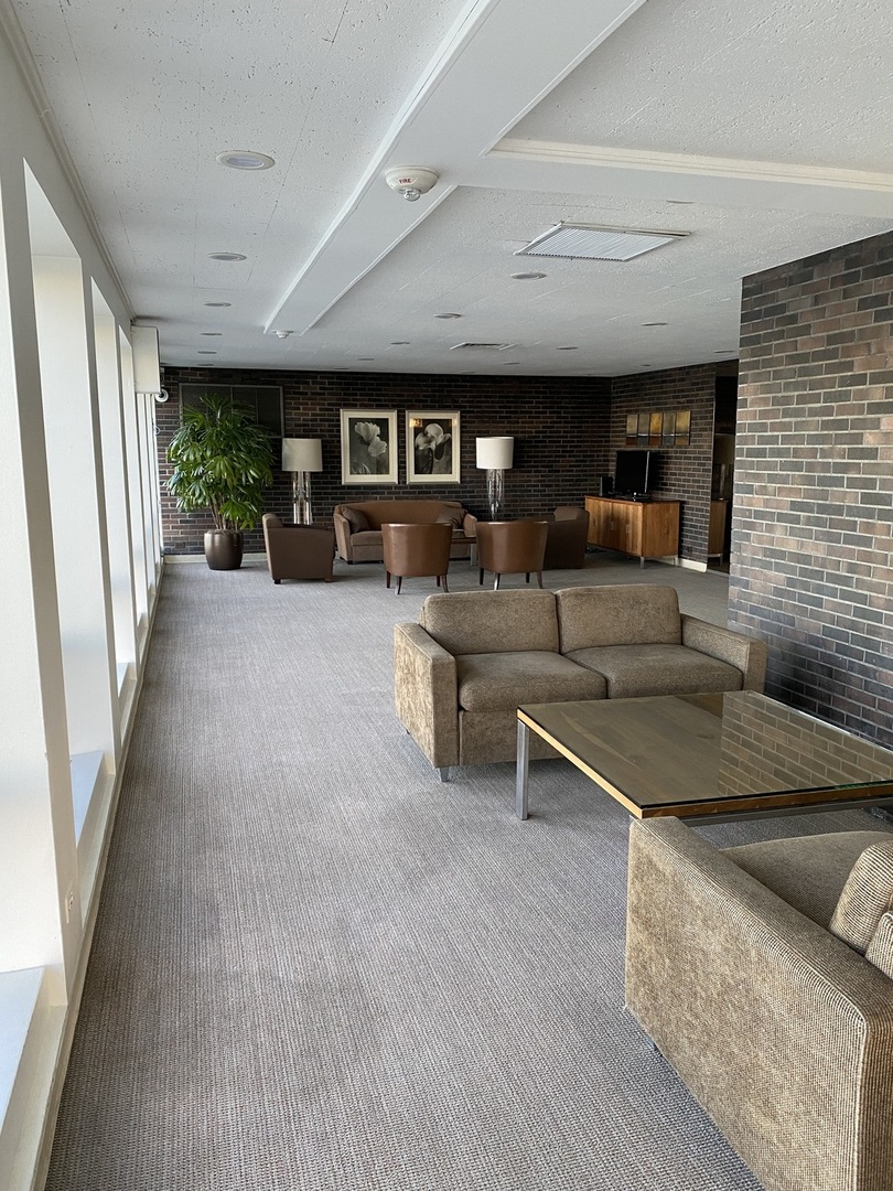 260 East Chestnut Street, Unit 708 Chicago, IL 60611 - Photo 11 of 12 a living room with furniture and a large window