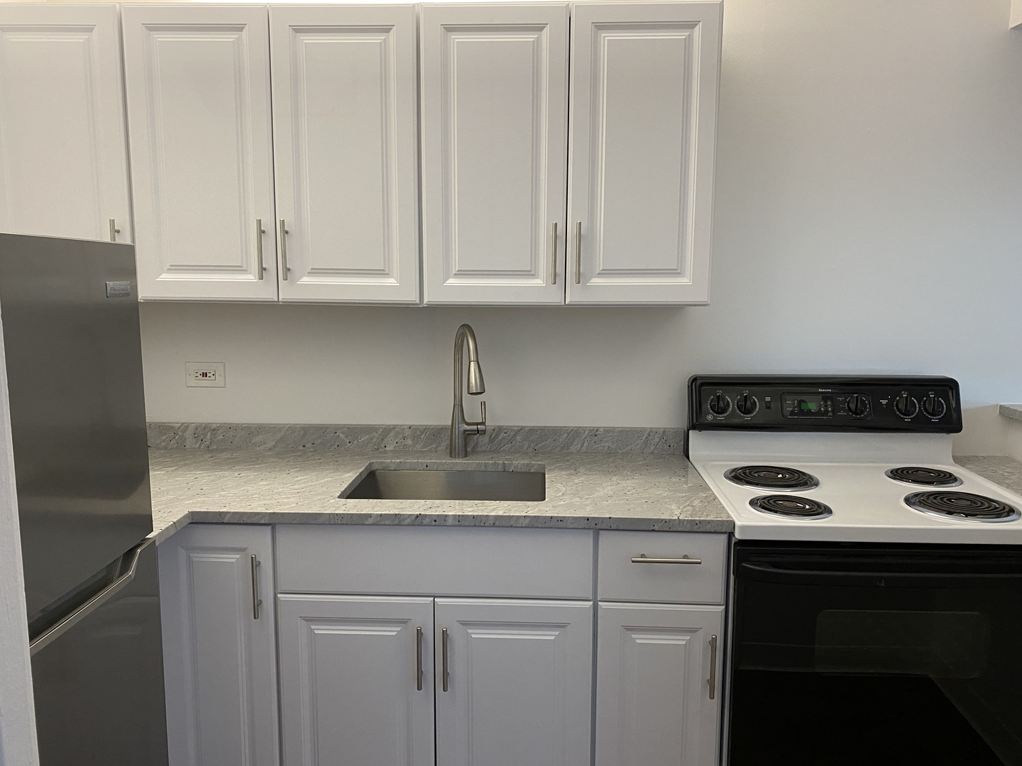 260 East Chestnut Street, Unit 708 Chicago, IL 60611 - Photo 6 of 12 a kitchen with granite countertop white cabinets and a sink