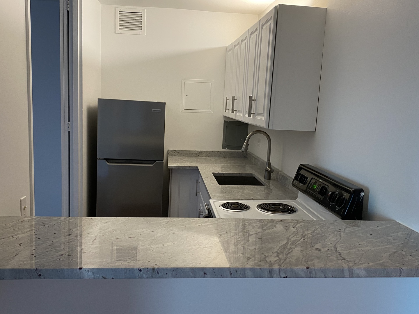 260 East Chestnut Street, Unit 708 Chicago, IL 60611 - Photo 7 of 12 a kitchen with stainless steel appliances granite countertop a refrigerator and a stove