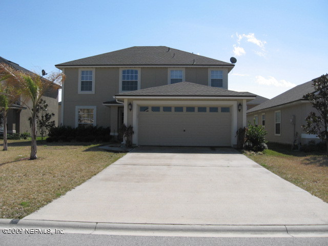 907 Silver Spring Court St. Augustine, FL 32092 - Photo 1 of 17 a front view of a house with garage