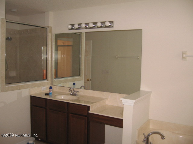 907 Silver Spring Court St. Augustine, FL 32092 - Photo 12 of 17 a bathroom with a sink and mirror