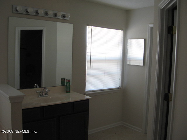 907 Silver Spring Court St. Augustine, FL 32092 - Photo 14 of 17 a bathroom with a sink vanity and a mirror